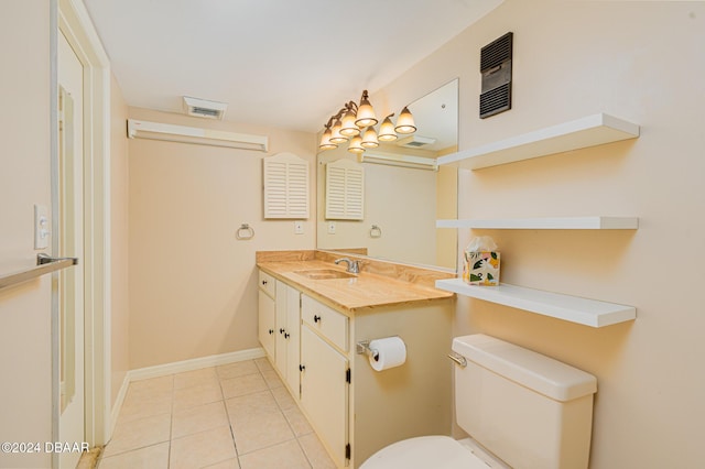 bathroom with tile patterned flooring, vanity, and toilet