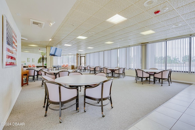 1 Oceans W Blvd Unit 7B1, Daytona Beach, FL 32118 - carpeted dining space with baseboards and tile patterned flooring
