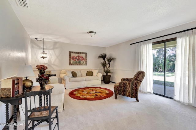 carpeted living room featuring a textured ceiling