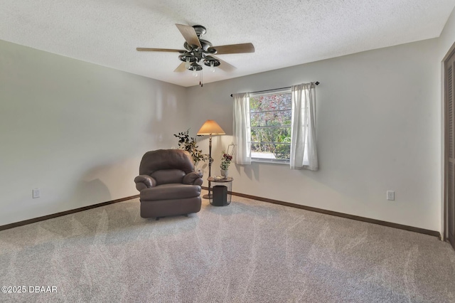 unfurnished room featuring ceiling fan, carpet, and a textured ceiling