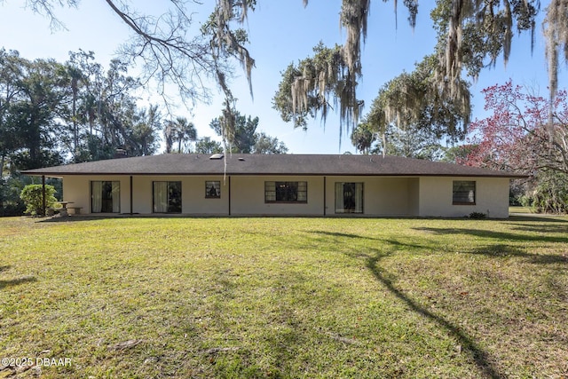 back of house with a yard