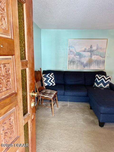 living room with light carpet and a textured ceiling