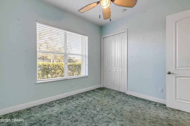 unfurnished bedroom with a ceiling fan, carpet, a closet, and baseboards