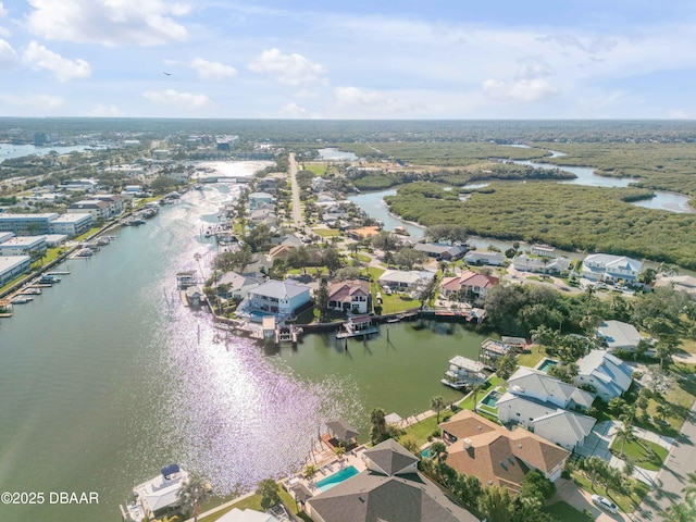 drone / aerial view with a water view and a residential view