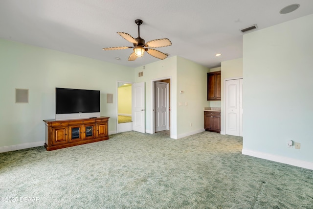 unfurnished living room with baseboards, visible vents, light colored carpet, ceiling fan, and recessed lighting