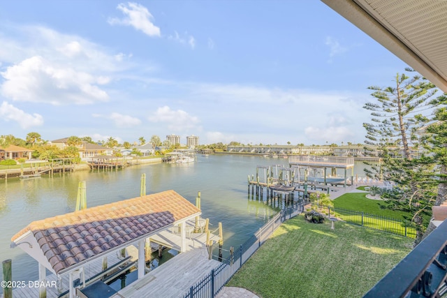 view of dock featuring a water view, a yard, and boat lift