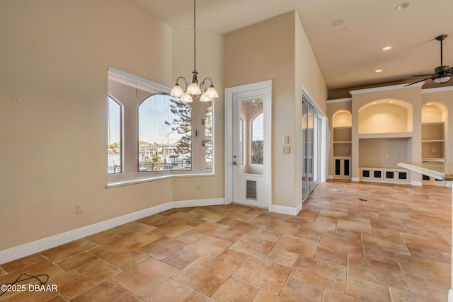 interior space featuring ceiling fan with notable chandelier, built in shelves, recessed lighting, and baseboards