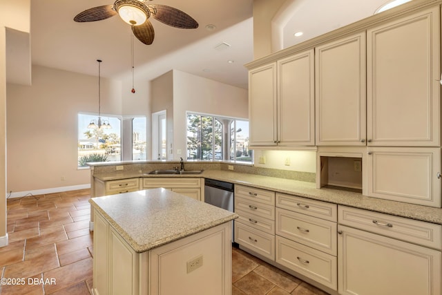 kitchen featuring cream cabinets, a peninsula, a sink, dishwasher, and pendant lighting