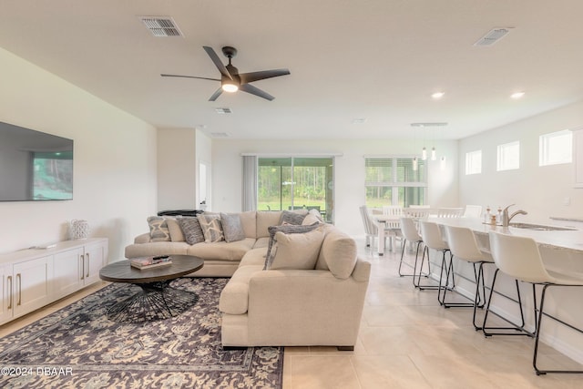 living area with ceiling fan, light tile patterned floors, and recessed lighting