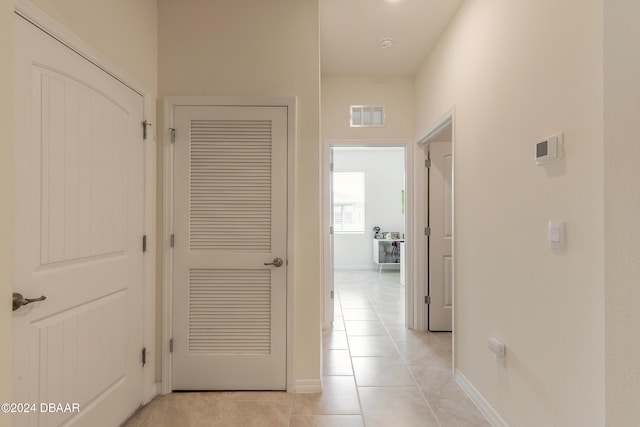 hallway featuring light tile patterned floors