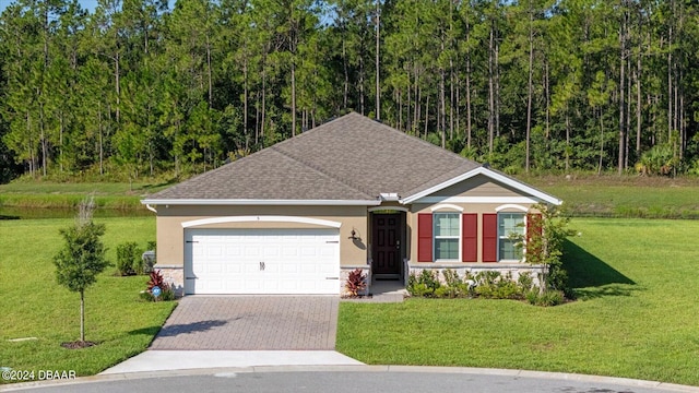 view of front of house featuring a front yard and a garage