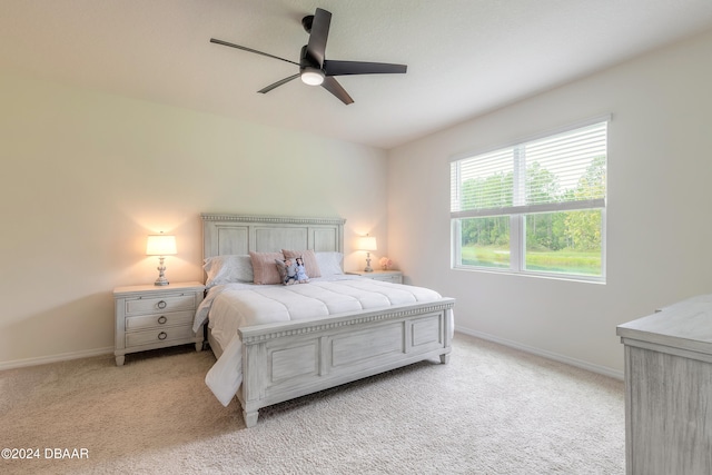 bedroom featuring light carpet and ceiling fan