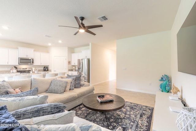 tiled living room featuring ceiling fan