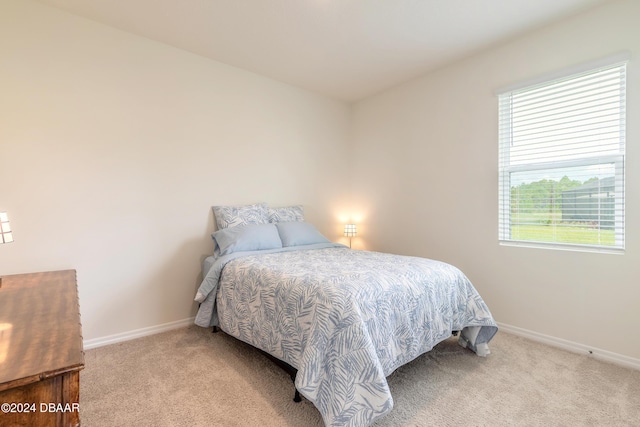bedroom with carpet and baseboards