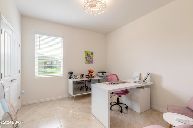 office space with baseboards and light tile patterned floors