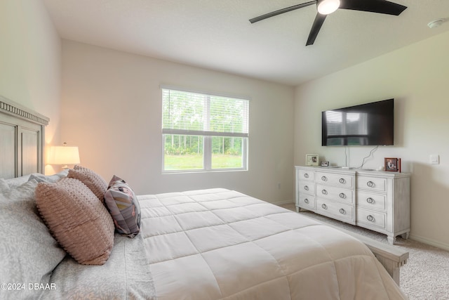 bedroom with light carpet and ceiling fan