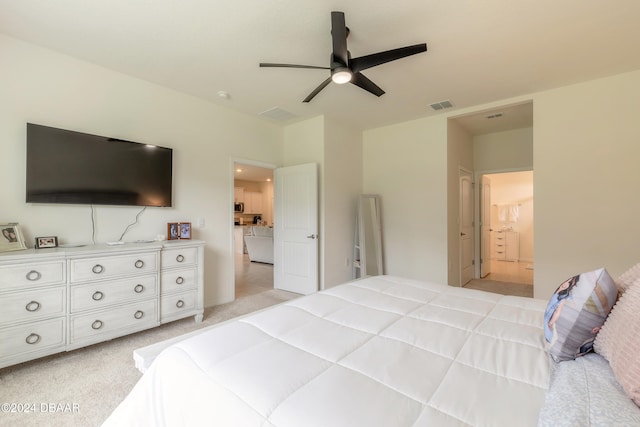 bedroom featuring ceiling fan, light carpet, and connected bathroom