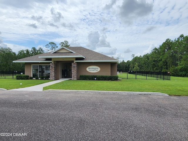 view of front of property featuring roof with shingles and stucco siding