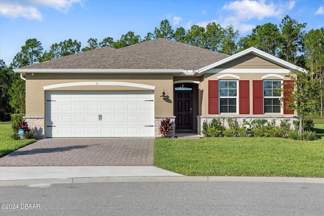 single story home featuring stone siding, a front lawn, driveway, and stucco siding