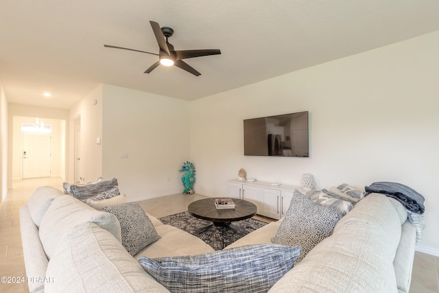 living room with ceiling fan and light tile patterned flooring