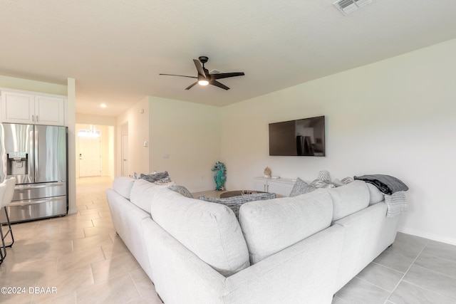 tiled living room featuring ceiling fan