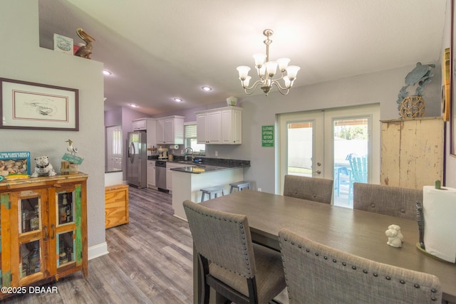 3324 Royal Palm Dr, Edgewater, FL 32141 - dining room with french doors, a chandelier, wood finished floors, and recessed lighting