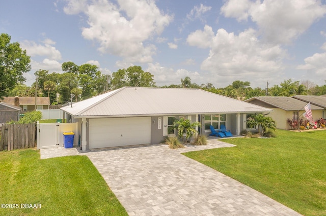 3324 Royal Palm Dr, Edgewater, FL 32141 - ranch-style home featuring an attached garage, driveway, stucco siding, and a metal roof
