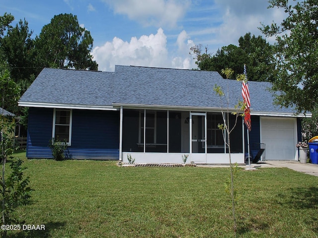 view of front facade featuring a shingled roof, concrete driveway, an attached garage, a sunroom, and a front yard