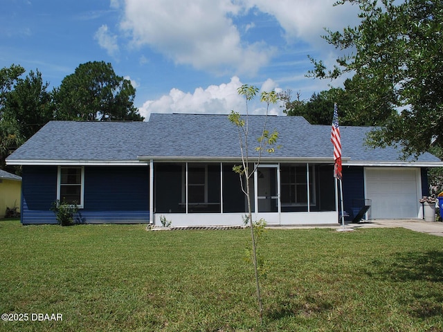 view of front of house featuring an attached garage, a front lawn, a sunroom, and roof with shingles