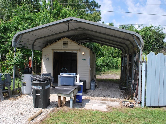 view of vehicle parking with a storage shed and a detached carport