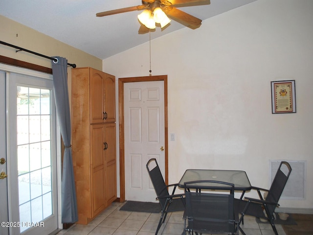 dining space with vaulted ceiling, visible vents, ceiling fan, and light tile patterned floors