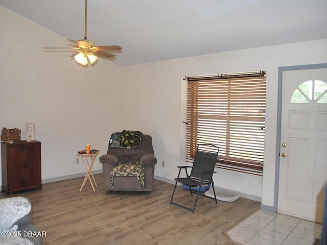 foyer entrance featuring light wood-style flooring, baseboards, and ceiling fan