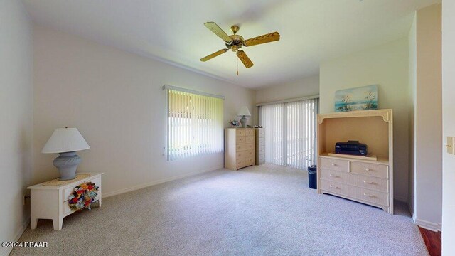 bedroom featuring ceiling fan and light carpet