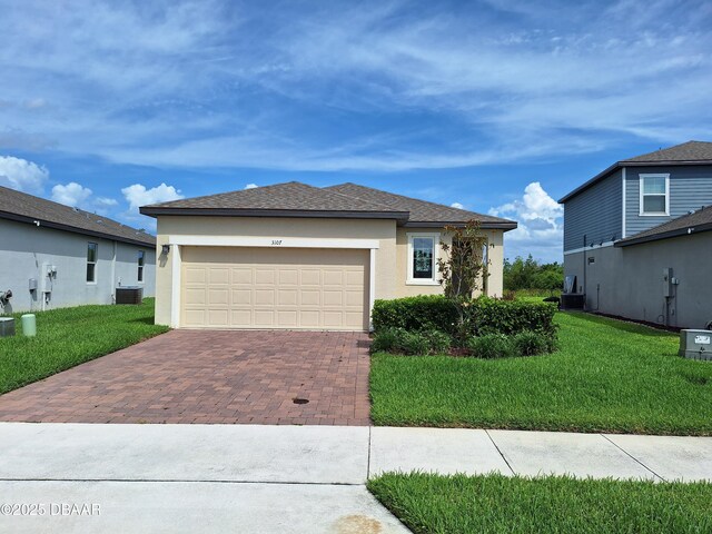 3107 Crab Trap Dr, New Smyrna Beach, FL 32168 - view of front of house with decorative driveway, a front yard, stucco siding, and an attached garage