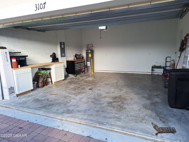 3107 Crab Trap Dr, New Smyrna Beach, FL 32168 - garage with water heater, a workshop area, a garage door opener, electric panel, and concrete block wall