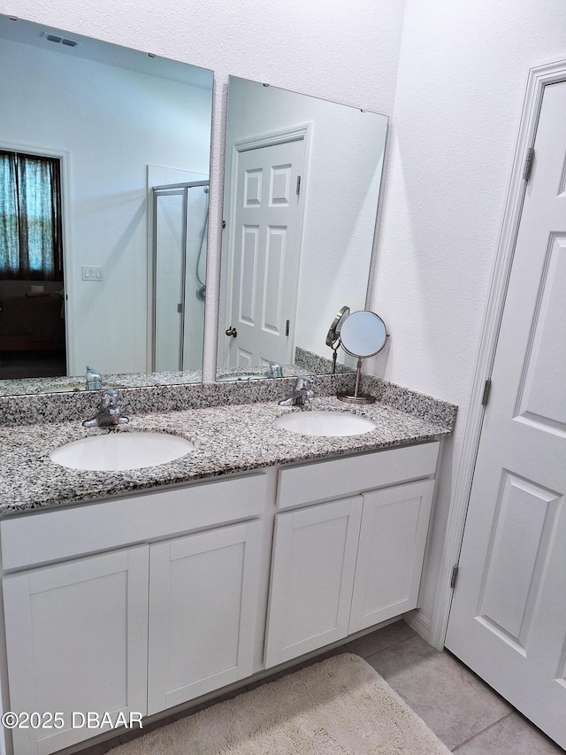 3107 Crab Trap Dr, New Smyrna Beach, FL 32168 - bathroom featuring double vanity, a shower stall, and tile patterned floors