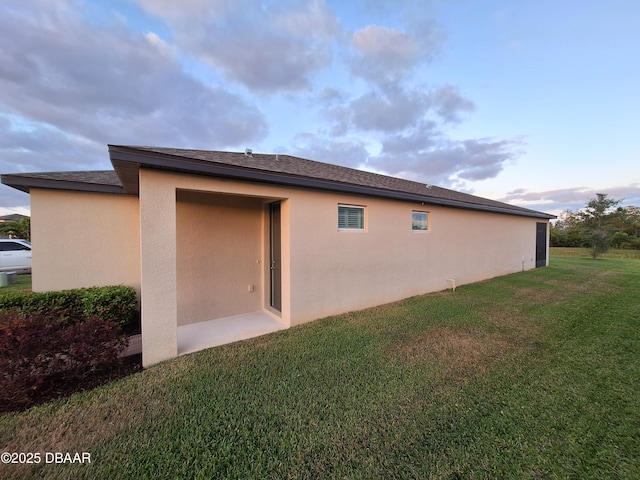 3107 Crab Trap Dr, New Smyrna Beach, FL 32168 - view of property exterior featuring stucco siding and a yard