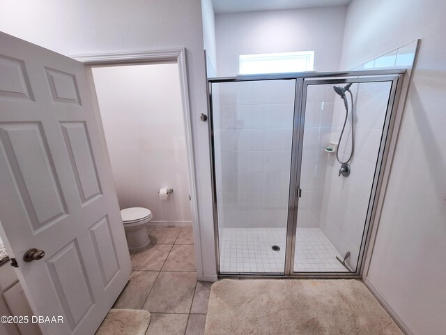 3107 Crab Trap Dr, New Smyrna Beach, FL 32168 - bathroom with toilet, a shower stall, and tile patterned floors