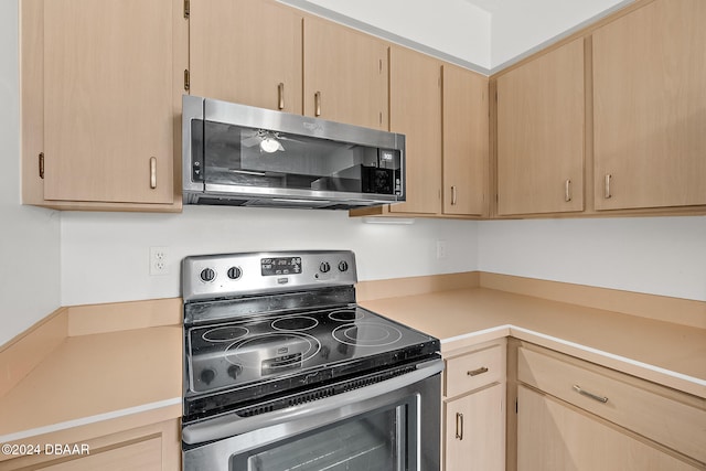 kitchen featuring stainless steel appliances and light brown cabinetry