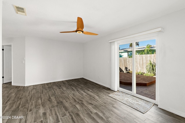 spare room with ceiling fan and dark wood-type flooring