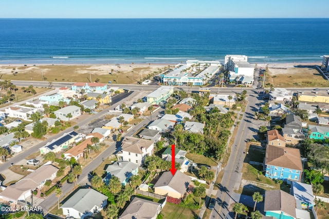 bird's eye view with a water view and a beach view