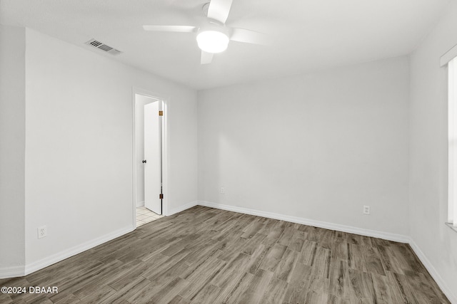 unfurnished room featuring ceiling fan and hardwood / wood-style floors