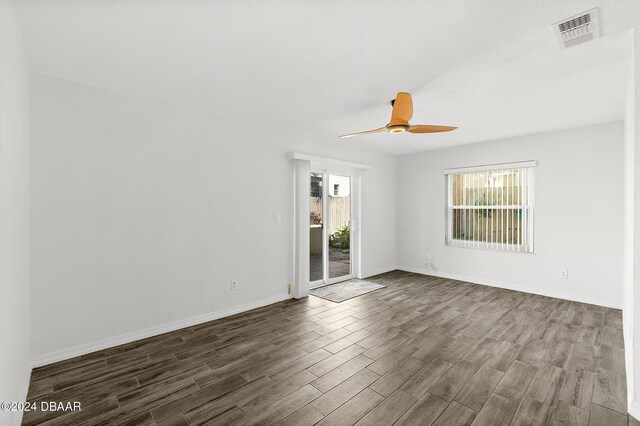 spare room featuring ceiling fan and dark hardwood / wood-style flooring