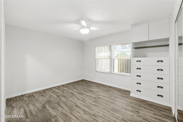 unfurnished bedroom featuring light hardwood / wood-style flooring and ceiling fan