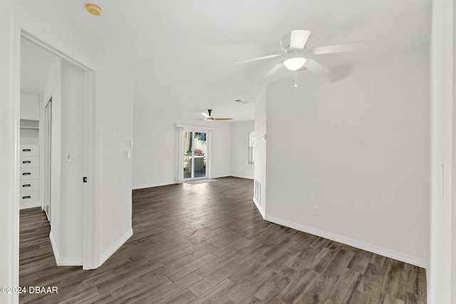 unfurnished living room with ceiling fan and dark hardwood / wood-style flooring