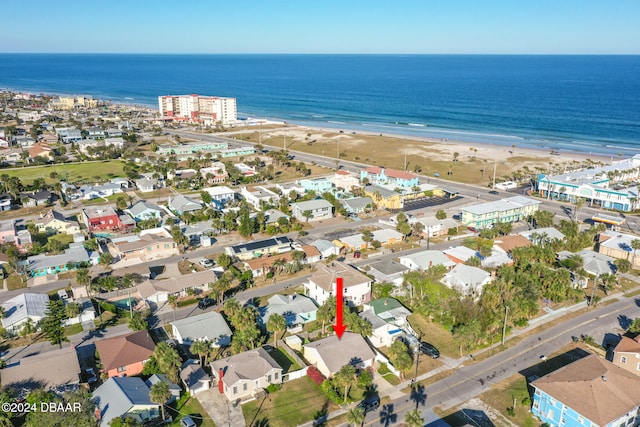 bird's eye view featuring a water view and a beach view