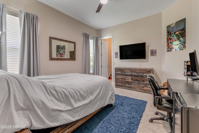 bedroom with carpet floors, an office area, and ceiling fan