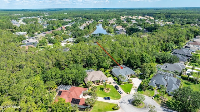 view of property location featuring a forest and nearby suburban area