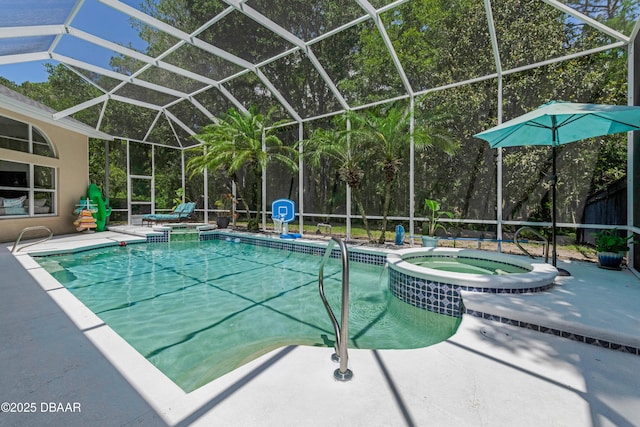 view of pool featuring a pool with connected hot tub, a patio, and glass enclosure