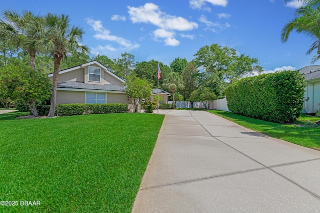 view of front of property featuring concrete driveway and stucco siding